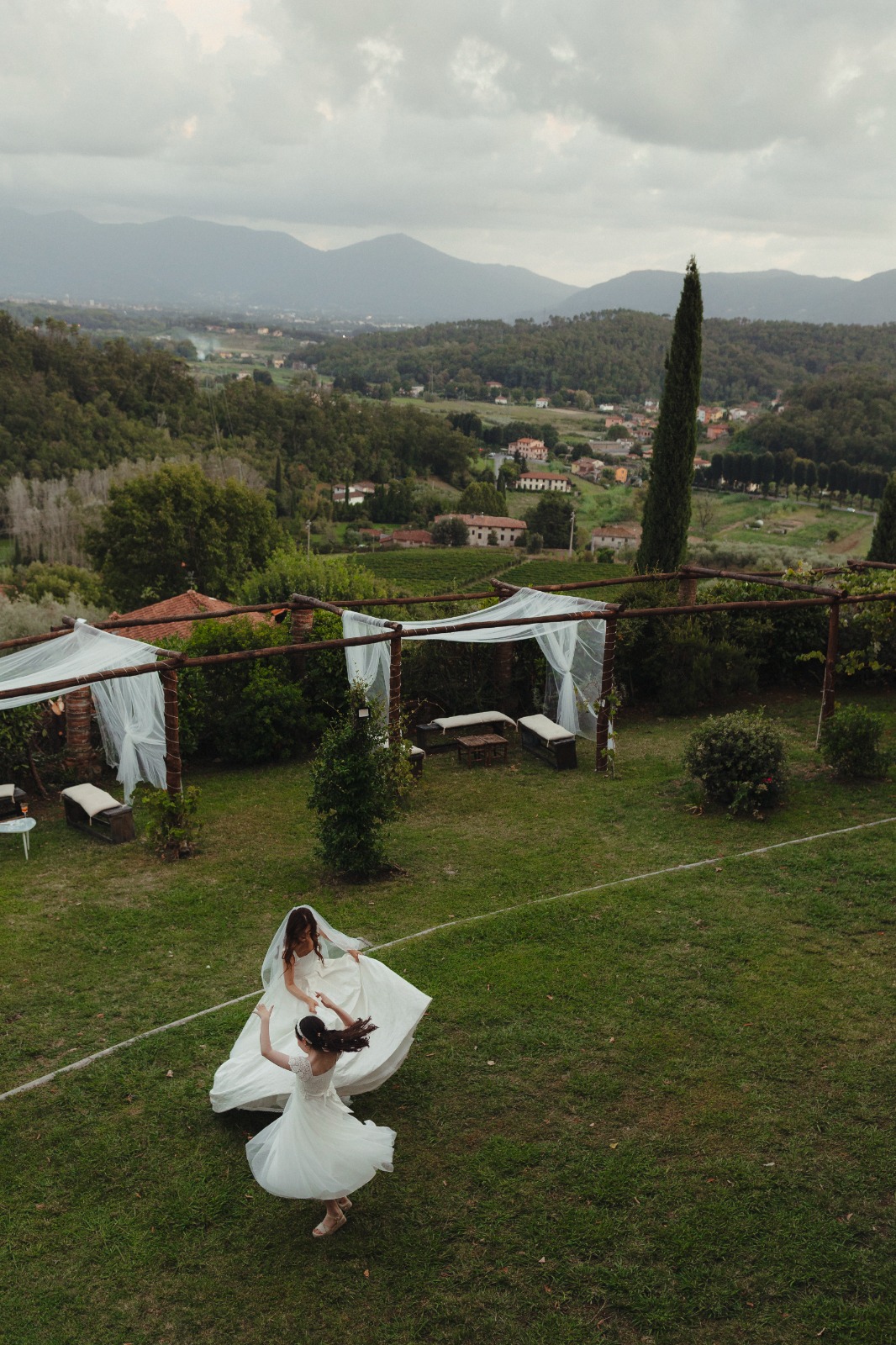Destination wedding in Italy - bride twirling at Tuscan villa with countryside views