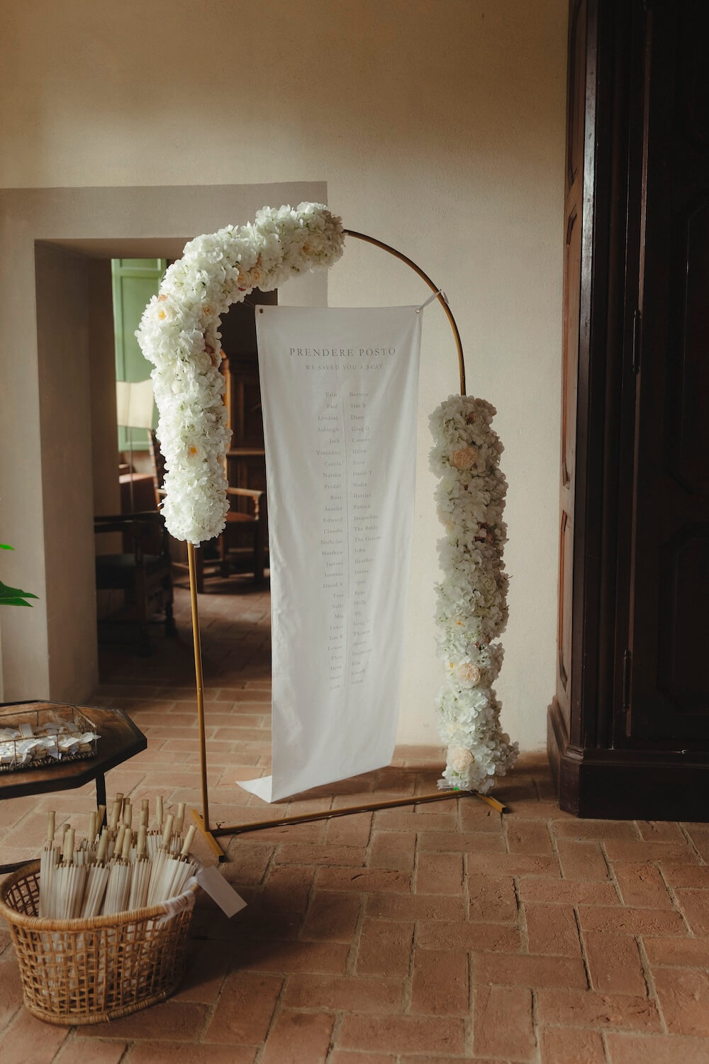 Destination wedding Italy - bespoke floral arch and seating plan decor