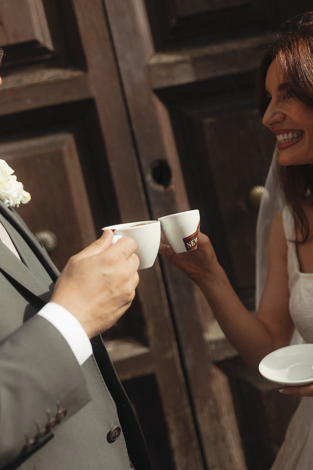 Getting married abroad in Italy - bride and groom sharing espresso in Lucca